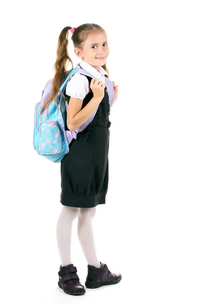 Porträt eines schönen kleinen Mädchens in Schuluniform mit Rucksack. isoliert — Stockfoto