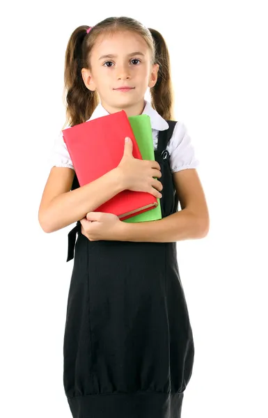 Bella bambina in uniforme scolastica e libri isolati su bianco — Foto Stock