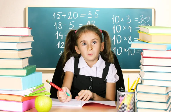 Little schoolchild in classroom near blackboard — Stock Photo, Image