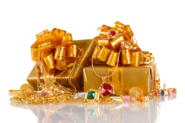 Various gold jewellery and gifts isolated on white