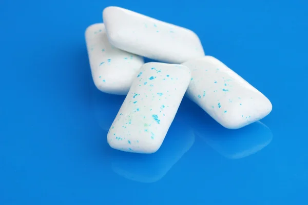 stock image Chewing gums on blue background