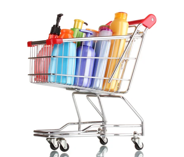 Shopping cart with detergent bottles isolated on white — Stock Photo, Image