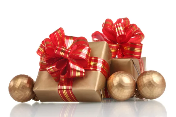 Beautiful golden gifts with red ribbon and Christmas balls isolated on whit — Stock Photo, Image