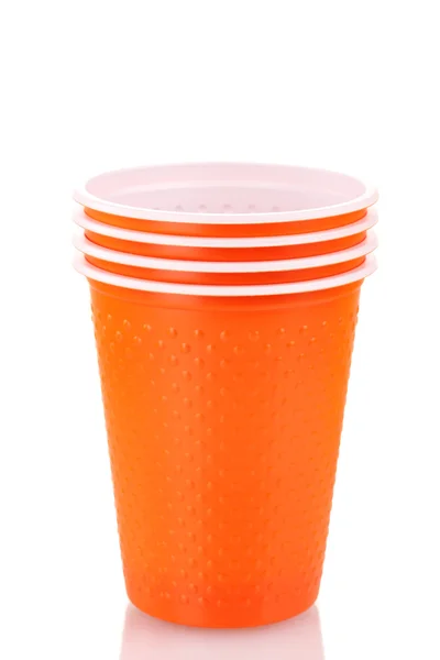 Bright orange plastic cups isolated on white — Stock Photo, Image