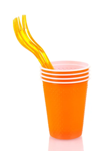 Bright orange plastic cups and forks isolated on white — Stock Photo, Image