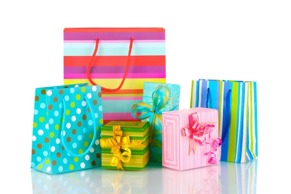 Bright gift bags and gifts isolated on white — Stock Photo, Image