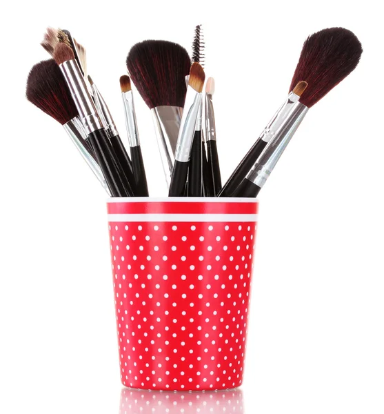 Red glass with brushes makeup isolated on white — Stock Photo, Image