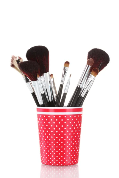 Red glass with brushes makeup isolated on white — Stock Photo, Image