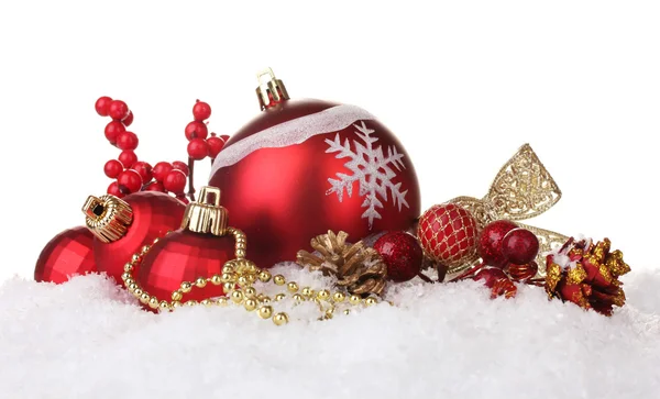 Красивые красные рождественские шары и шишки на снегу изолированы на белом — стоковое фото