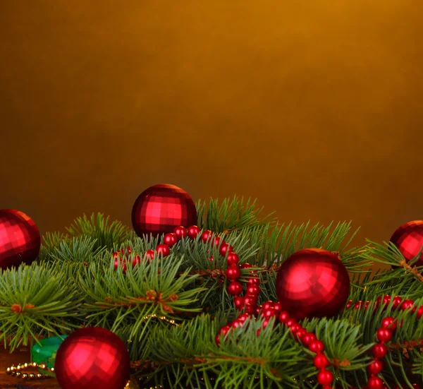 Christmas tree with beautiful New Year's balls on brown background — Stock Photo, Image