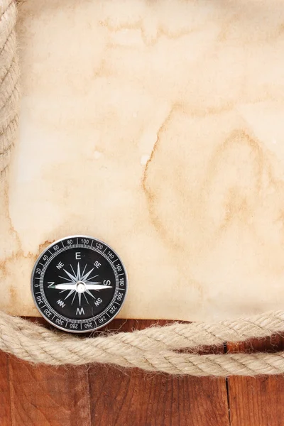 stock image Old paper, compass and rope on a wooden table