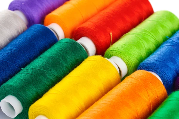 Many-coloured bobbins of thread closeup — Stock Photo, Image