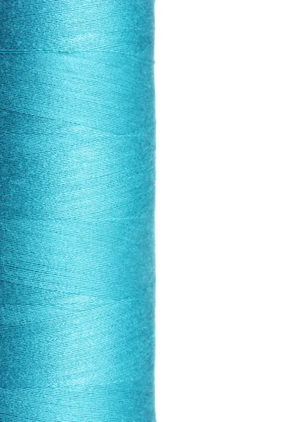 stock image Blue bobbin thread isolated on white