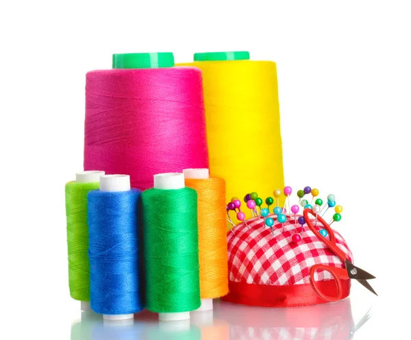 Bobbins of thread with colored pinheads in pin-cushion isolated on white — Stock Photo, Image