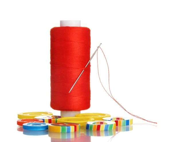 Red bobbin with needle and buttons isolated on white — Stock Photo, Image