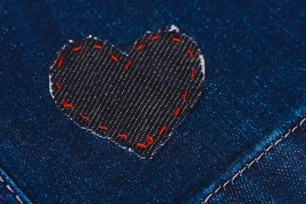 Heart-shaped patch on jeans closeup — Stock Photo, Image