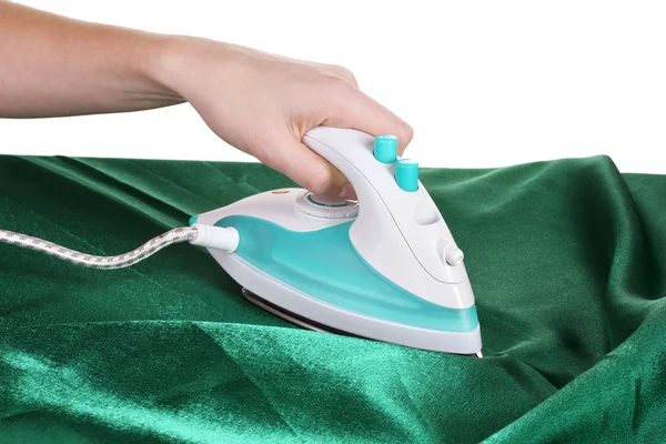 Electric iron on green cloth isolated on white — Stock Photo, Image