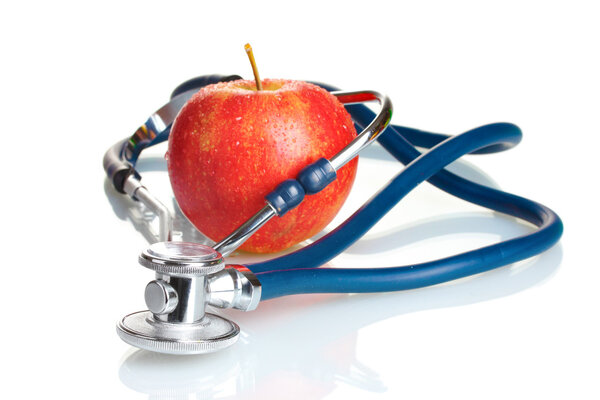 Medical stethoscope and red apple isolated on white