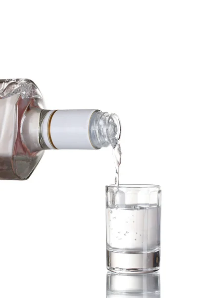Vodka poured into a glass isolated on white — Stock Photo, Image
