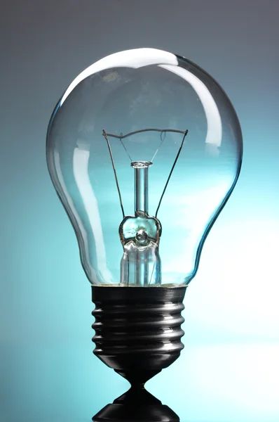 stock image Light bulb on blue background