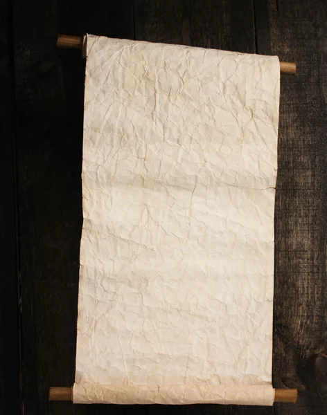 Old scroll on wooden background — Stock Photo, Image