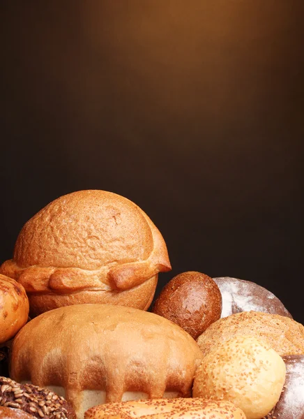 Delizioso pane su tavolo di legno su sfondo marrone — Foto Stock