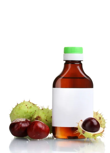 Green and brown chestnuts and medical bottle isolated on white — Stock Photo, Image
