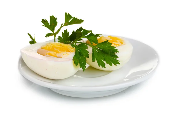 Tasty boiled eggs and parsley on plate isolated on white — Stock Photo, Image