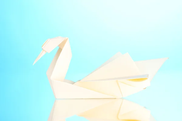 Origami papír labuť na modrém pozadí — Stock fotografie