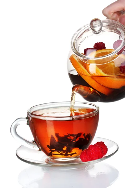 Szklany czajniczek wlanie czarnej herbaty do filiżanki izolowane na białym — Zdjęcie stockowe