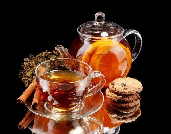 Bule de vidro e xícara com chá de frutas pretas e biscoitos isolados em branco — Fotografia de Stock