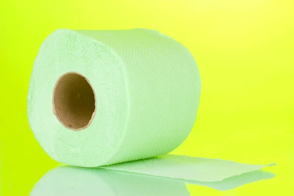 Green roll of toilet paper on green background — Stock Photo, Image