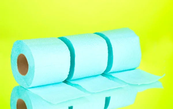 Blue rolls of toilet paper on green background — Stock Photo, Image
