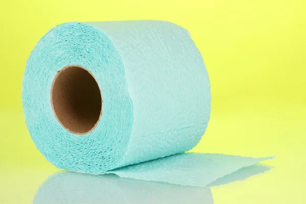 Blue roll of toilet paper on yellow background — Stock Photo, Image