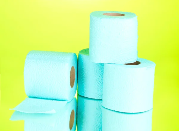 Blue rolls of toilet paper on green background — Stock Photo, Image