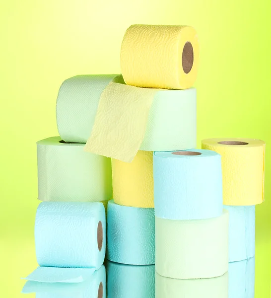 Bright rolls of toilet paper on green background — Zdjęcie stockowe