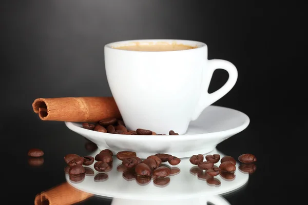 Чашка кофе, корицы и кофейных зерен на черном фоне — стоковое фото