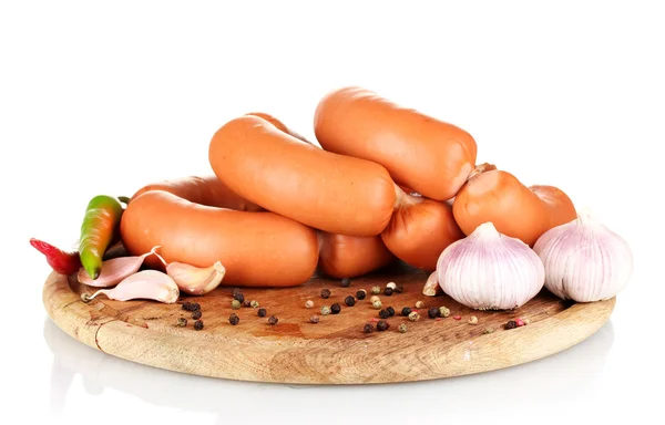 Tasty sausages on wooden board and spices isolation on white — Stock Photo, Image