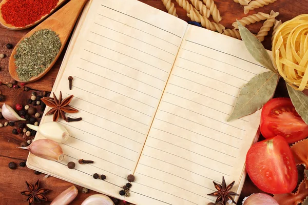 Cuaderno para recetas y especias en mesa de madera — Foto de Stock