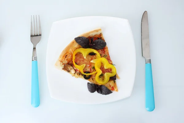 stock image Delicious slice of pizza on plate, knife and fork isolated on white