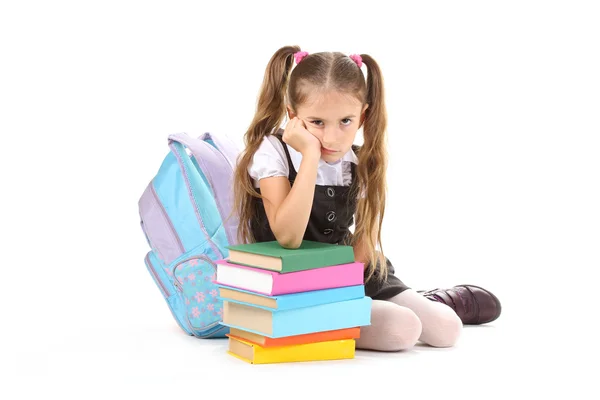 Beautiful little girl, books and a backpack isolated on white Stock Image