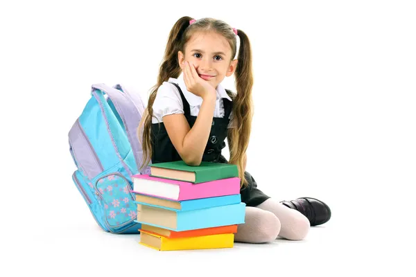 Beautiful little girl, books and a backpack isolated on white Stock Photo