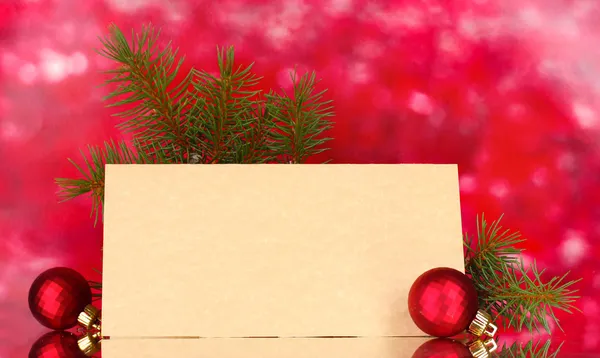 Blank postcard, Christmas balls and fir-tree on red background Stock Photo