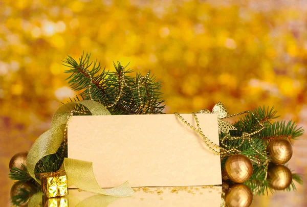 Blank postcard, Christmas balls and fir-tree on yellow background Royalty Free Stock Images