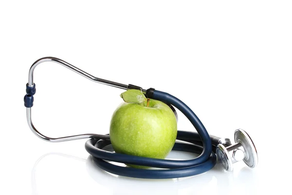 Medicinsk stetoskop och grönt äpple isolerad på vit Stockbild