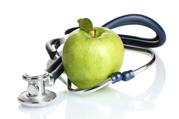 Медицинский стетоскоп и зеленое яблоко изолированы на белом Лицензионные Стоковые Фото