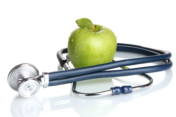Medicinsk stetoskop och grönt äpple isolerad på vit Stockbild