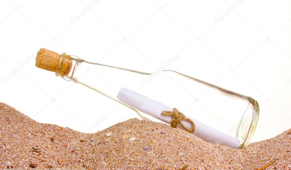 Glass bottle with note inside on sand on white background