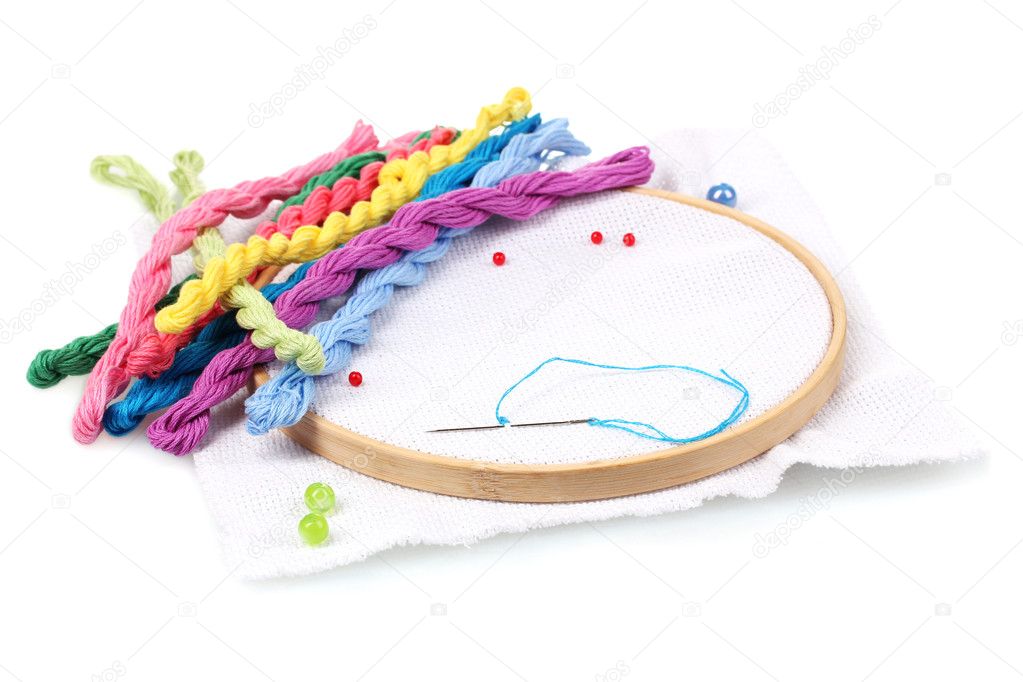 The embroidery hoop with canvas and bright sewing threads for embroidery is