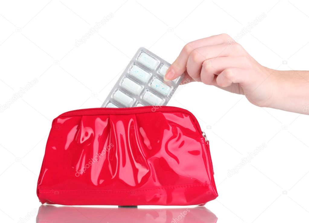Chewing gums wrapped in golden foil in hand and cosmetic bag isolated on wh